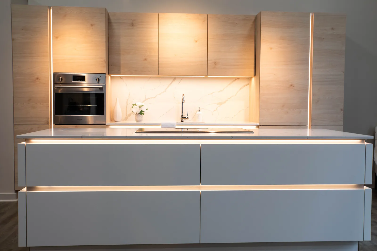 Oak and white Nolte kitchen with lit handle channels