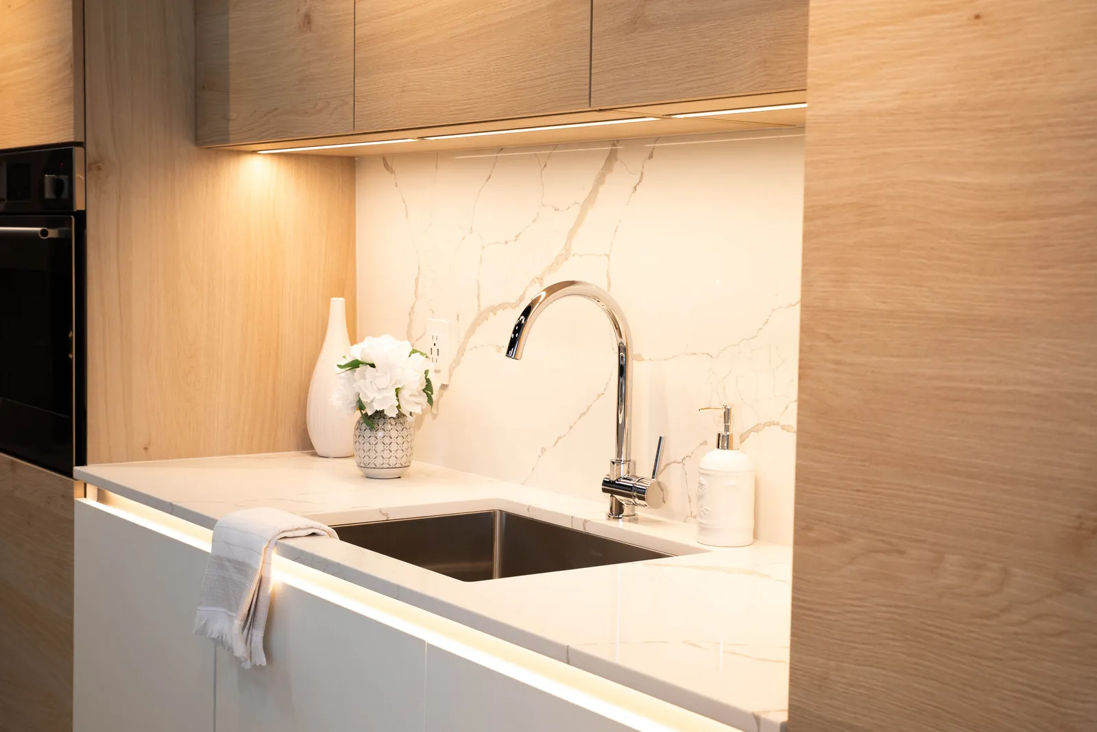 Warm oak and white, with lit handle channels