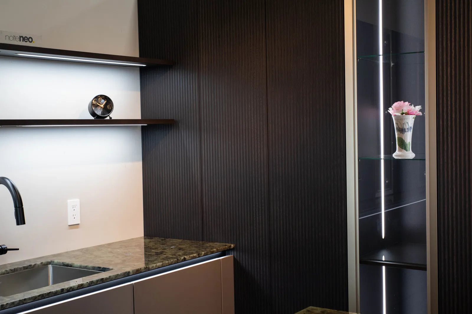 Dark wood Nolte kitchen with glass cabinet